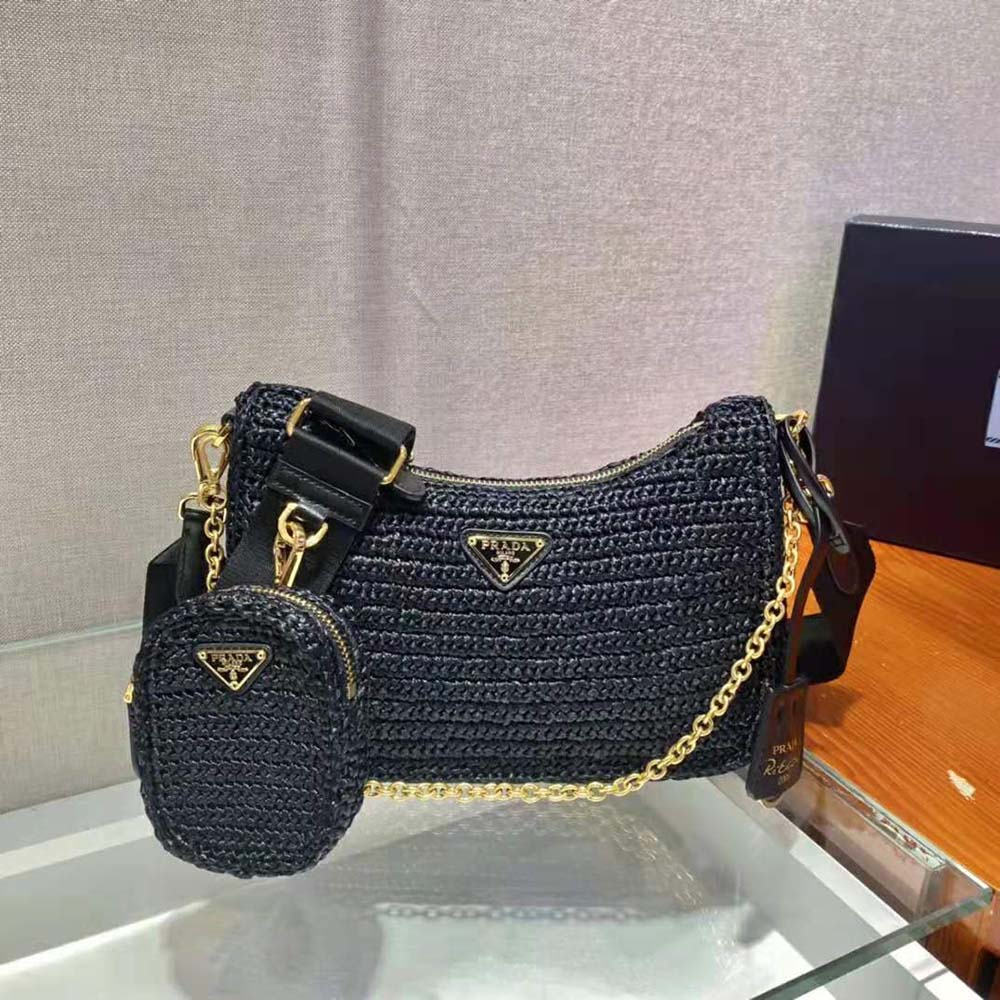 Side angle of Prada Women Re-Edition 2005 Raffia Bag-Black with leather strap