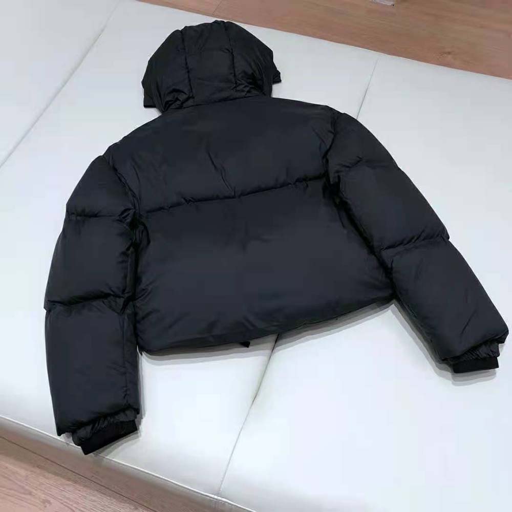 Side angle highlighting tailored silhouette of Prada nylon puffer jacket