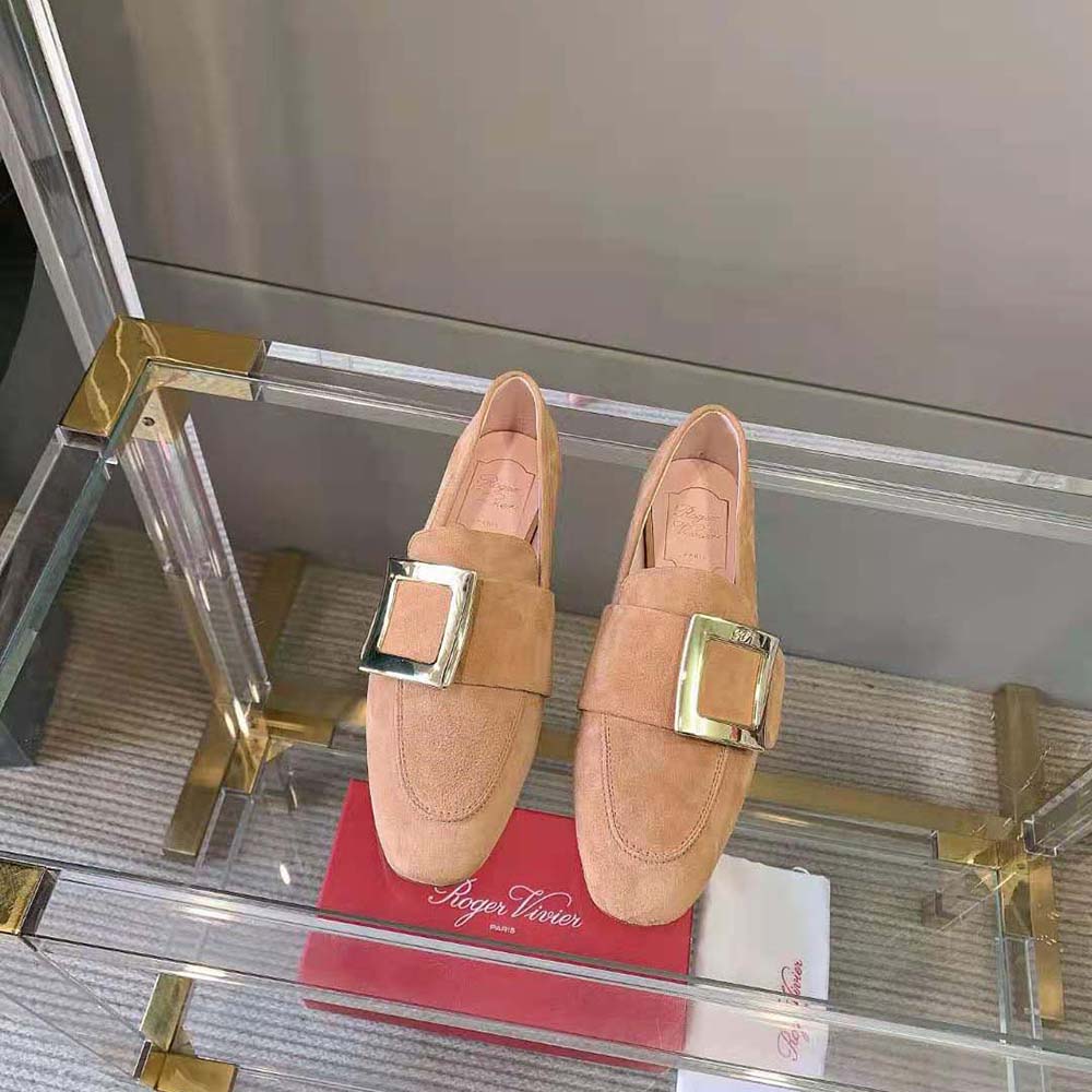 Close-up of soft metal buckle detail on Roger Vivier brown suede loafers