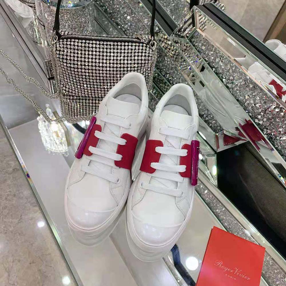 Close-up of oversized silver buckle on pink Roger Vivier Viv Skate Sneakers
