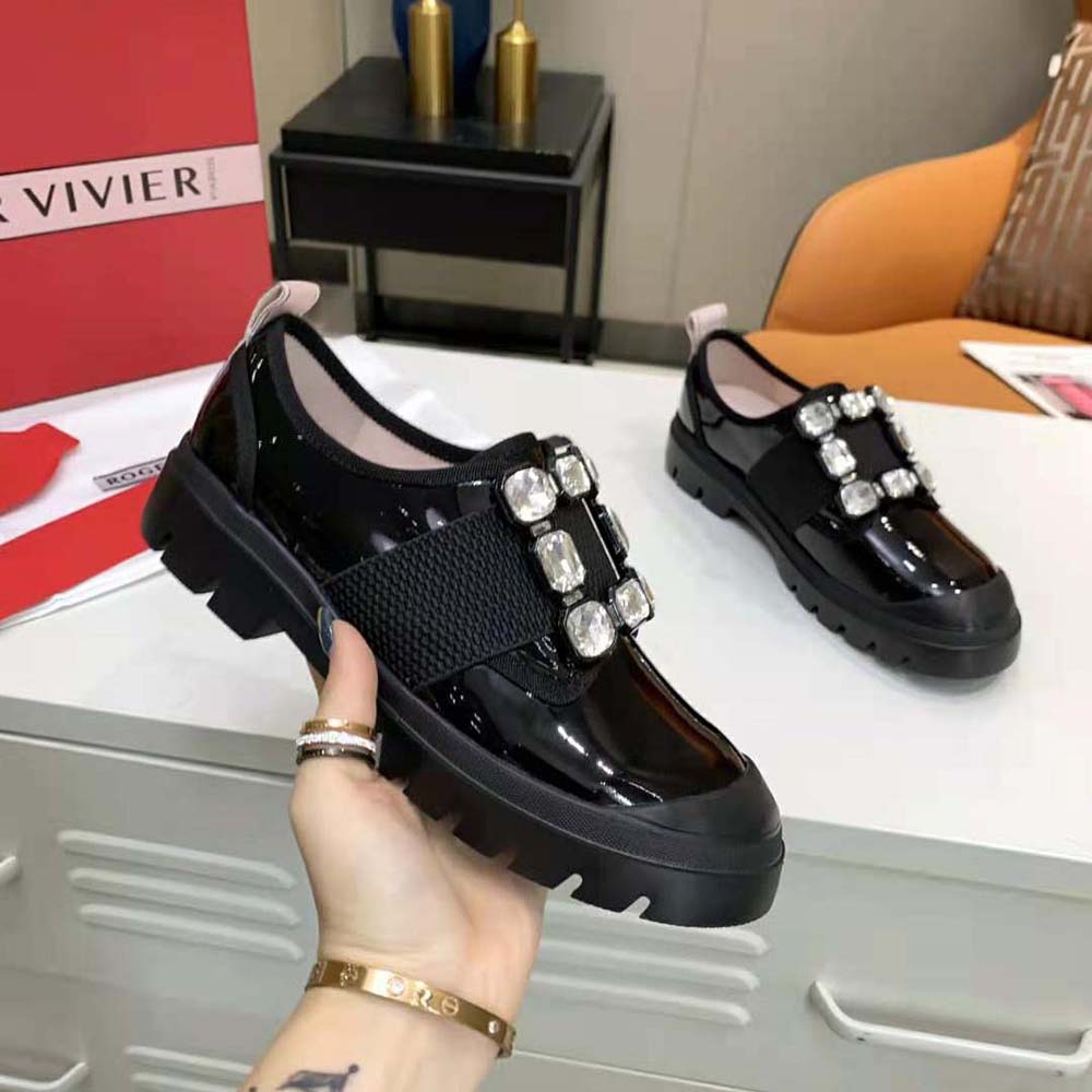 Close-up of crystal Strass buckle on Roger Vivier Women Walky Viv’ patent leather sneakers