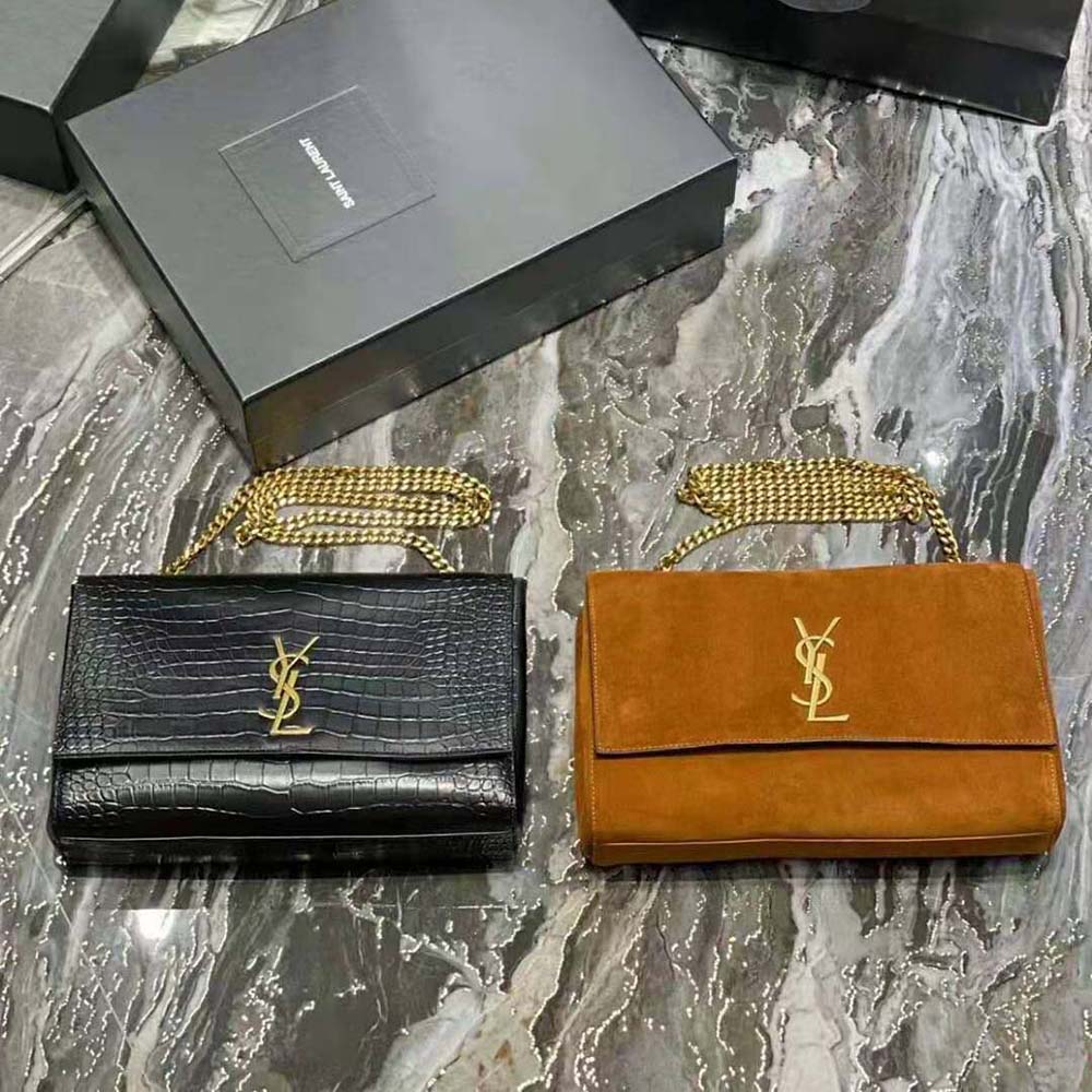 Close-up of crocodile-embossed leather and YSL logo hardware detail