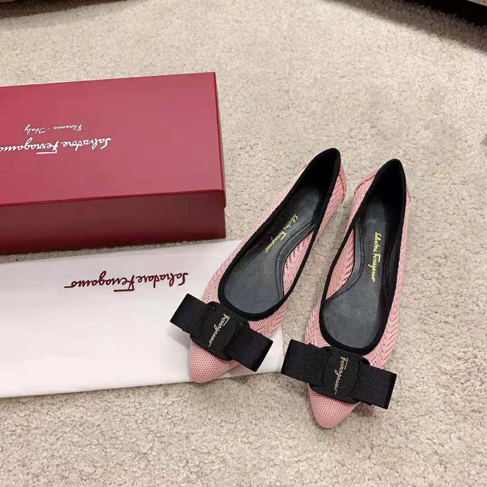 Close-up detail of signature bow on ballet flat in pink leather