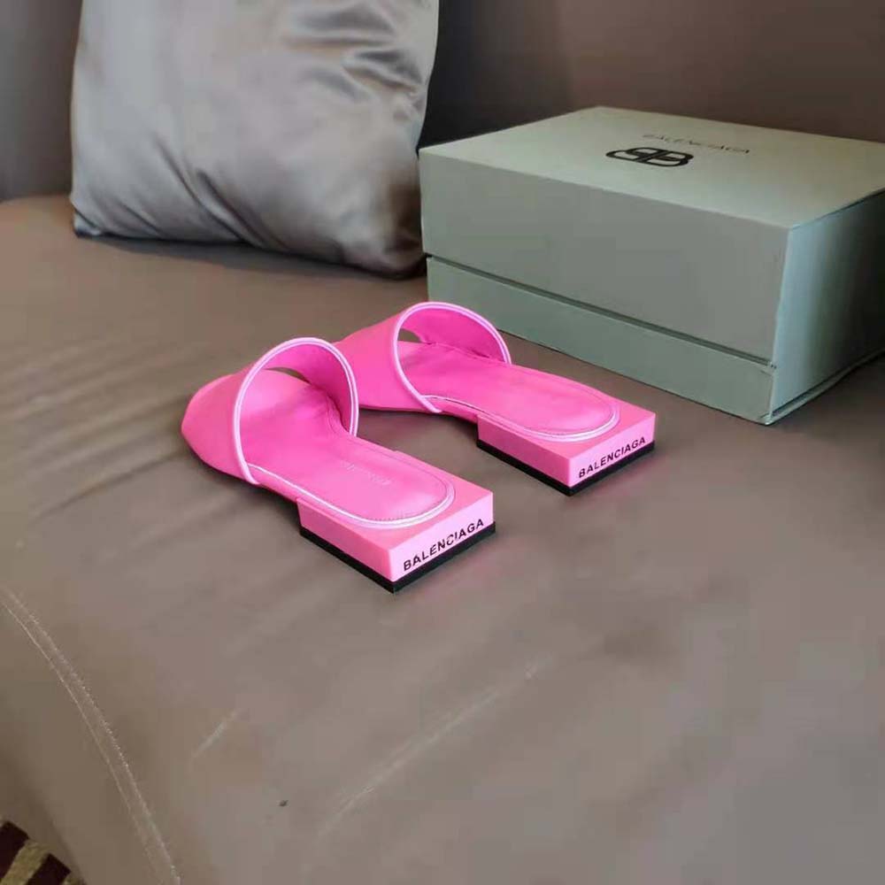 Close-up of pink smooth sheepskin and embossed logo on mule
