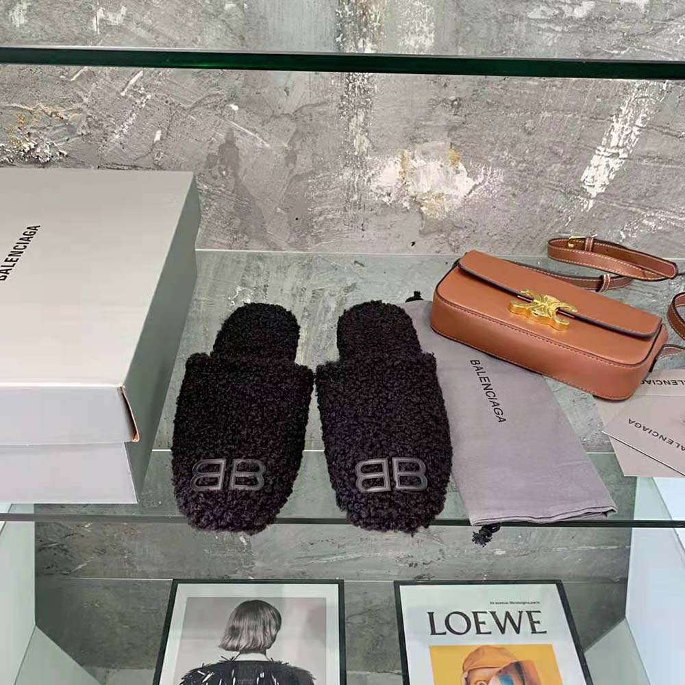 Close-up of black faux shearling texture and BB logo on mule