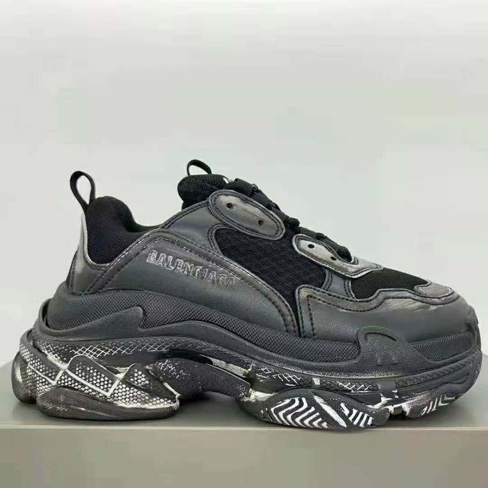 Close-up of laces and logo hardware on Balenciaga Triple S Faded Sneaker