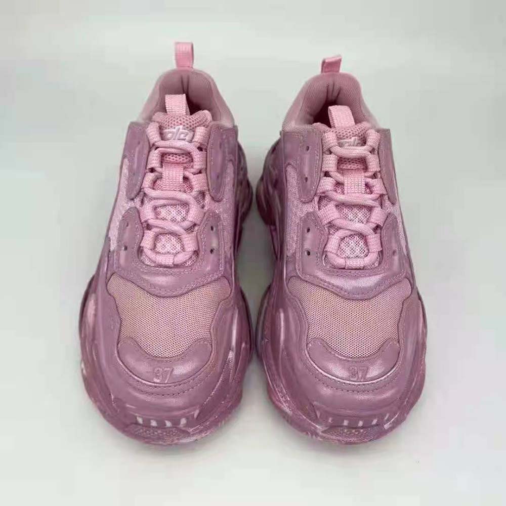Close-up of washed pink leather and embossed logo on sneaker