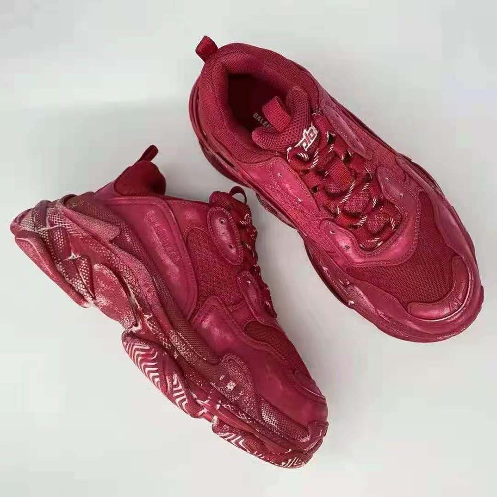 Close-up of red distressed leather and laces on Balenciaga Women Triple S Faded Sneaker