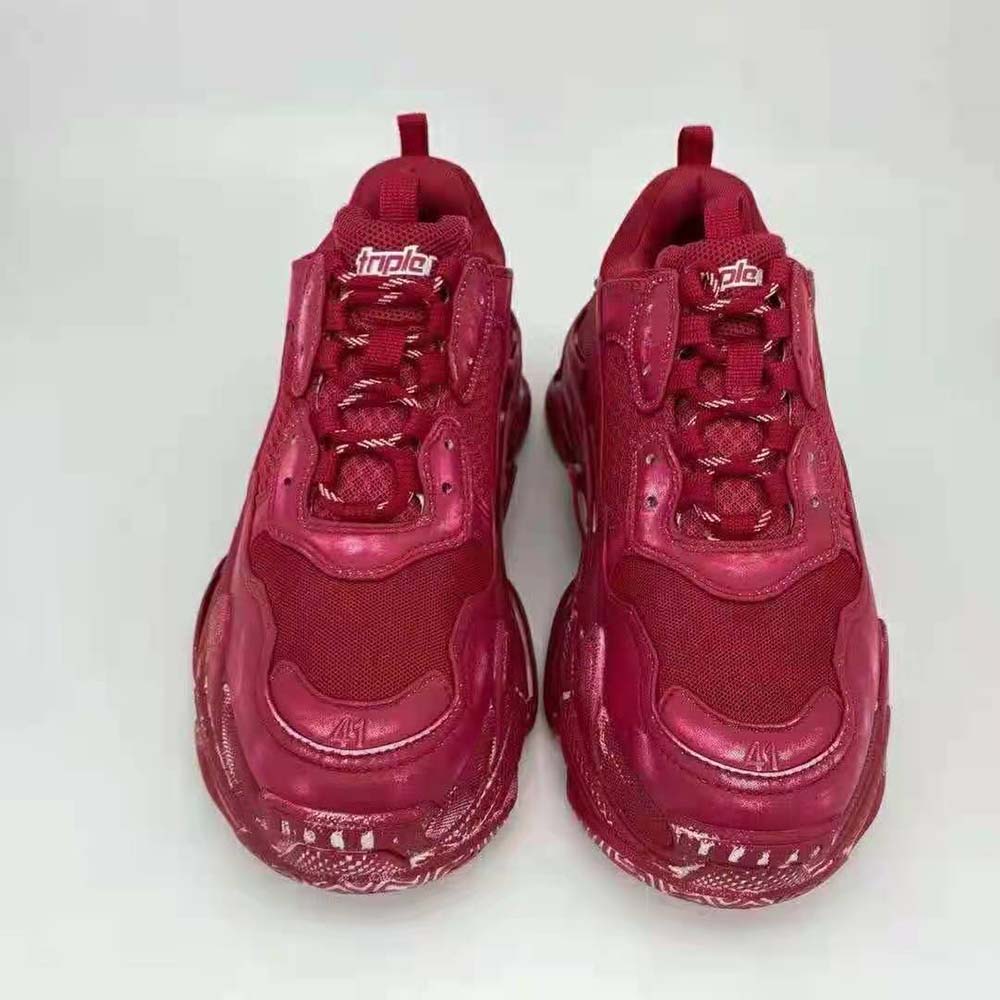 Top view highlighting embroidered Balenciaga logo on tongue of red Triple S sneaker