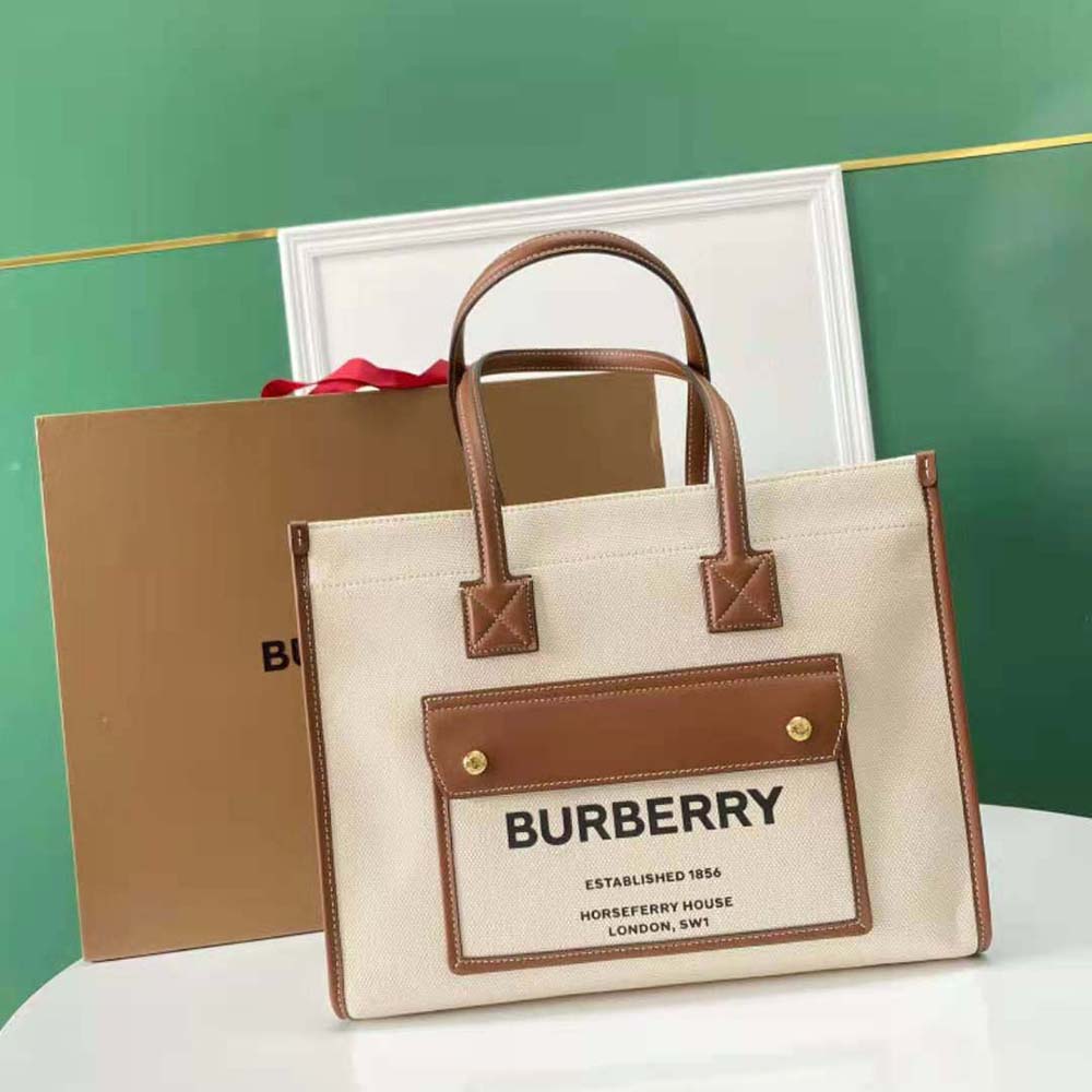 Close-up on gold-tone closure detail of Burberry Freya Tote-Brown