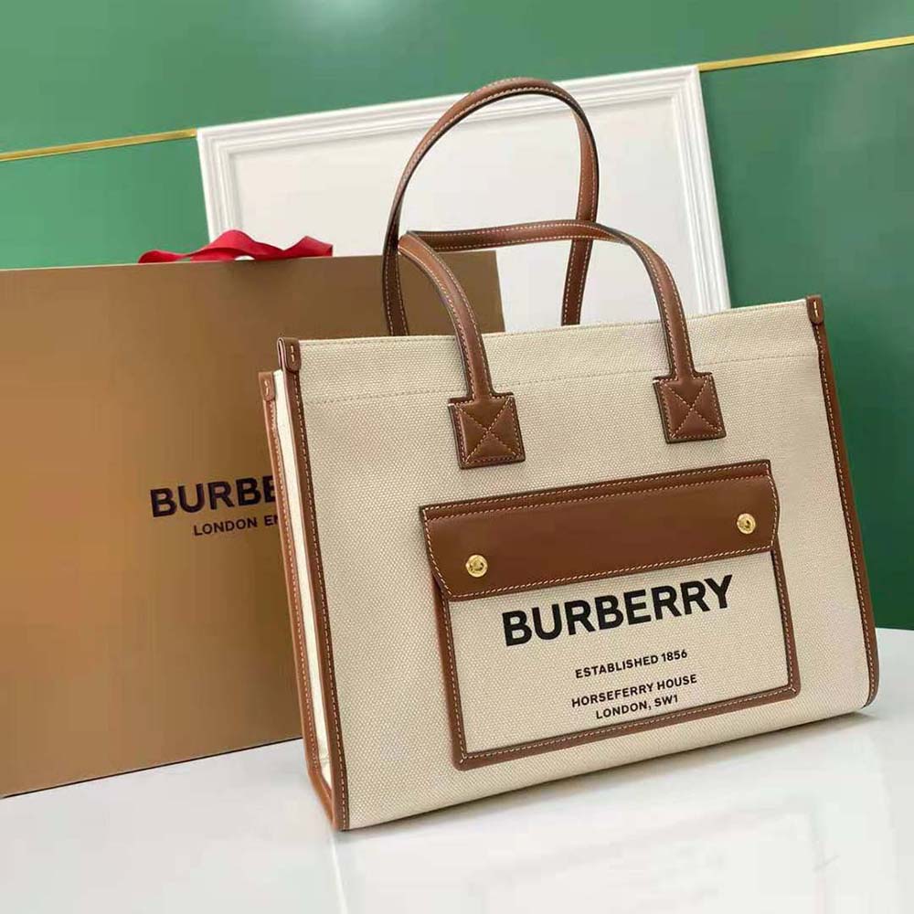 Side angle showing leather trim and canvas texture on Burberry Freya Tote