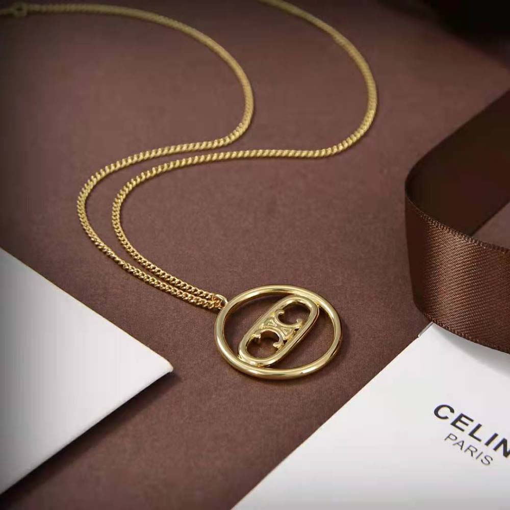 Close-up of signature Triomphe link detail on bold gold necklace