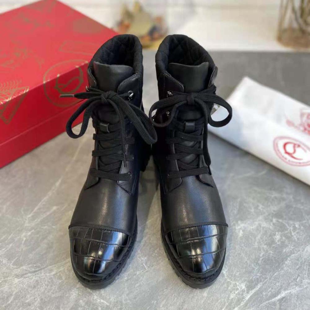 Close-up of signature red sole and spikes on Christian Louboutin women Mayr boot