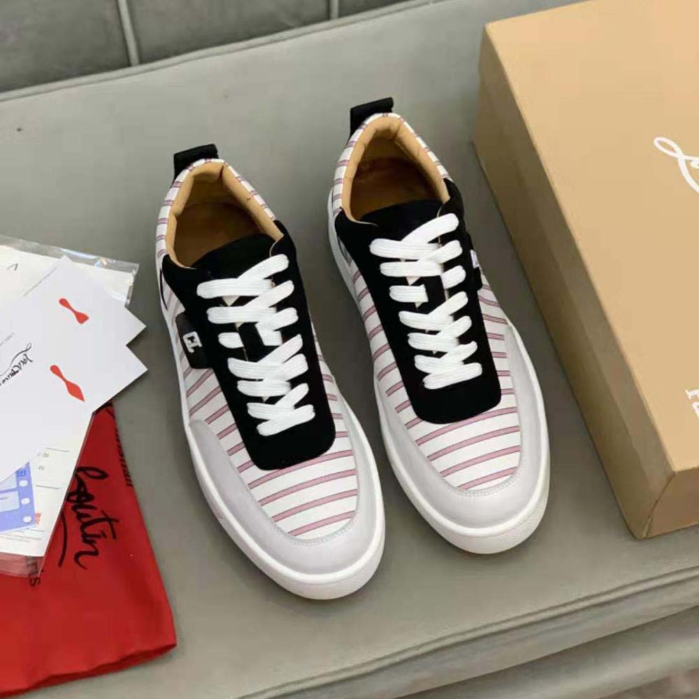 Close-up of white leather and signature red sole detail