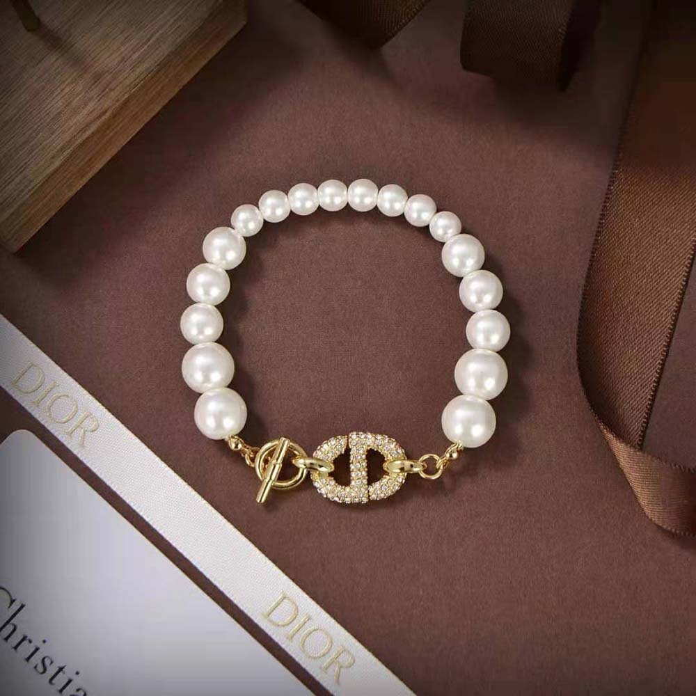 Side view of Dior Women CD Navy Bracelet Gold-Finish Metal on wrist
