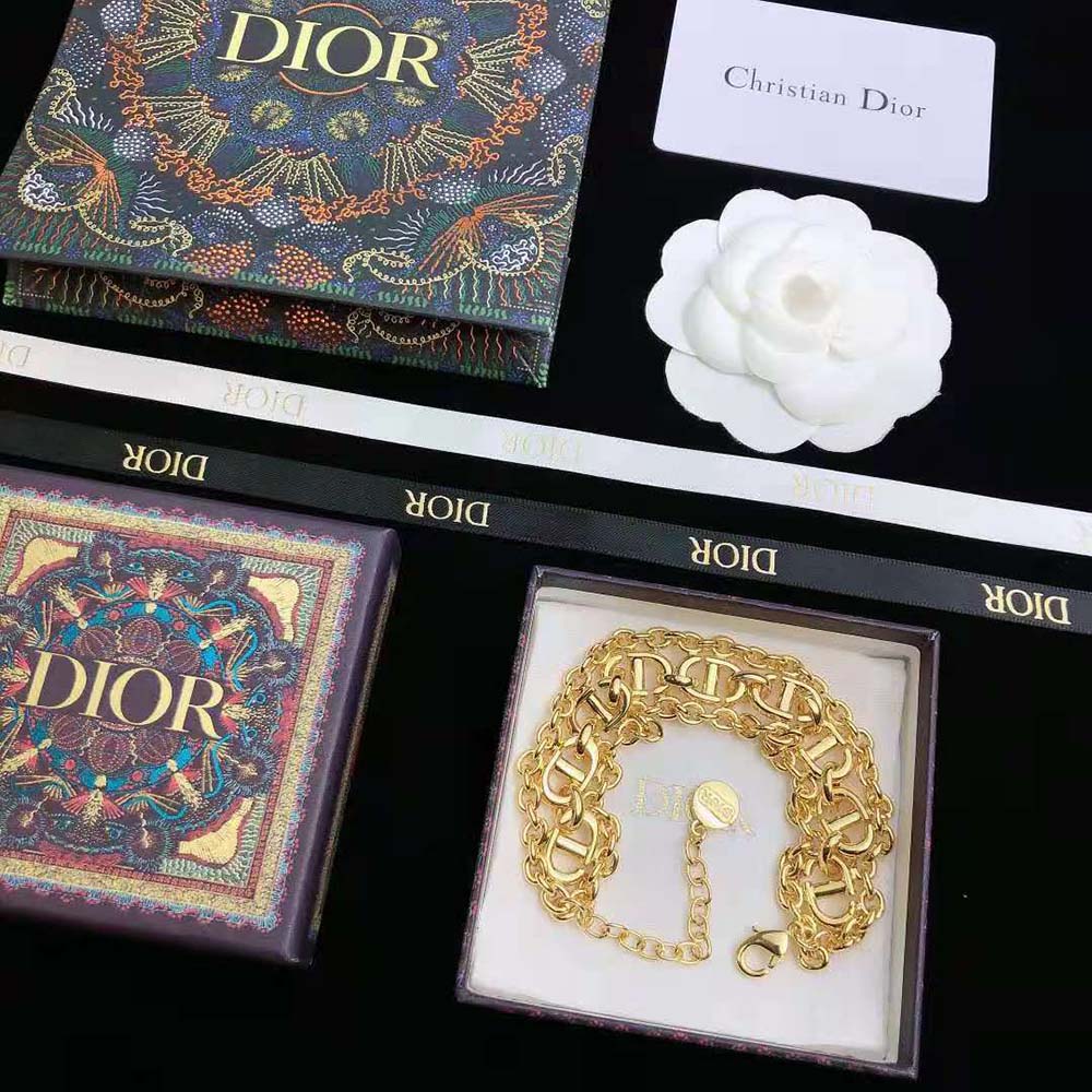 Model wrist featuring Dior Women CD Navy Bracelet Gold-Finish Metal shine
