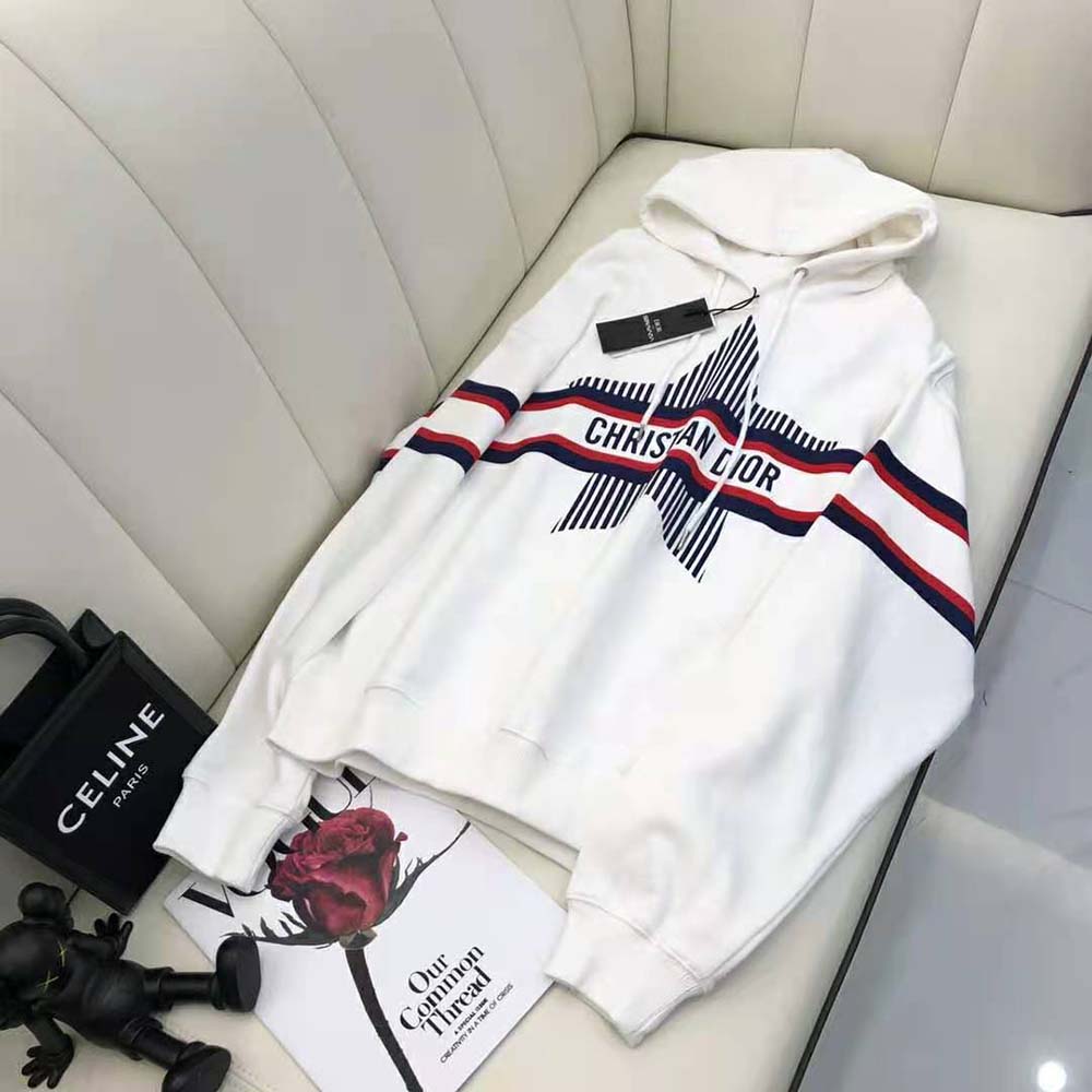 Close-up of three-tone Dior star embroidery on sweatshirt sleeve