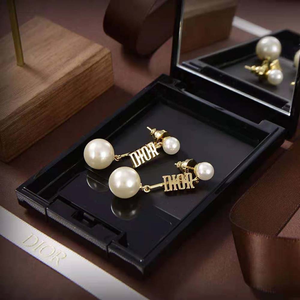 Close-up detail of white resin pearls and gold-finish metal on Dior Women Dio(r)evolution Earrings