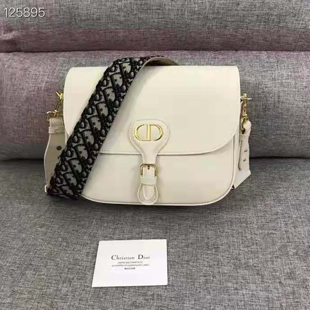 Close-up of box calfskin texture and silver buckle on Dior Women Large Dior Bobby Bag Box Calfskin-White