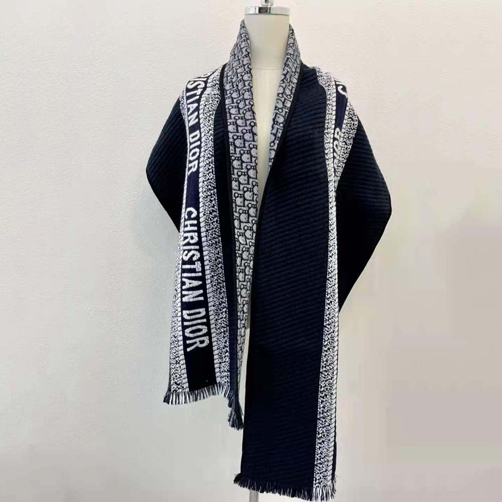 Close-up showing Dior Oblique pattern on reversible navy blue scarf