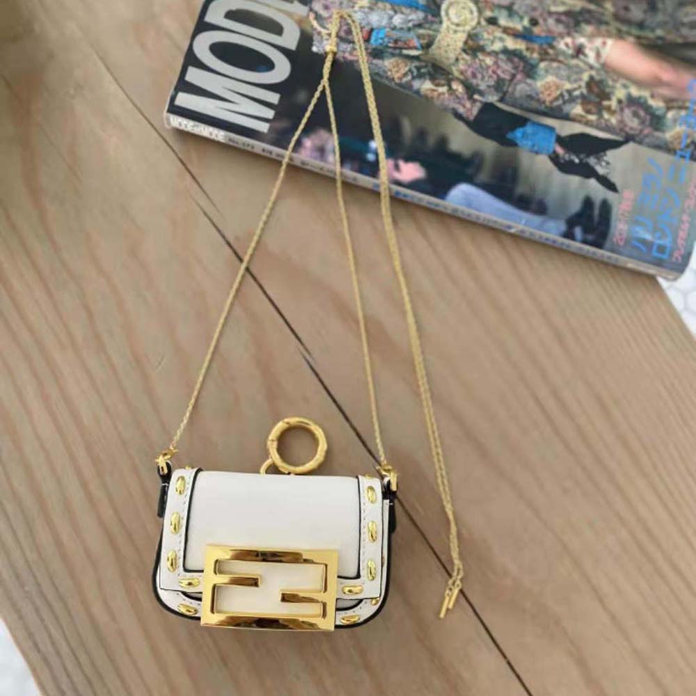 Close-up of gold-tone hardware and charm detail on Fendi Women Nano Baguette