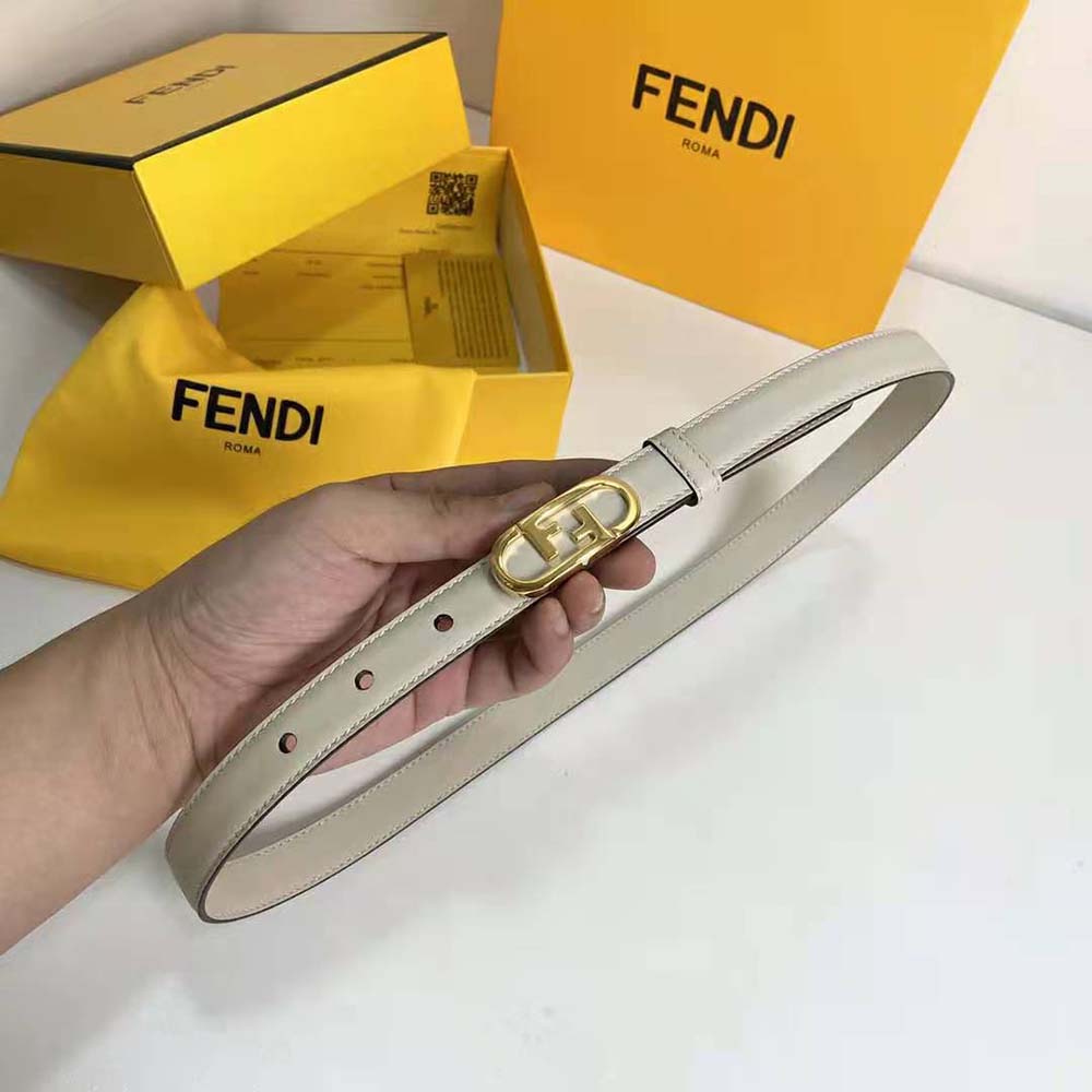 Close-up detail of Fendi O Lock stud buckle on white narrow belt