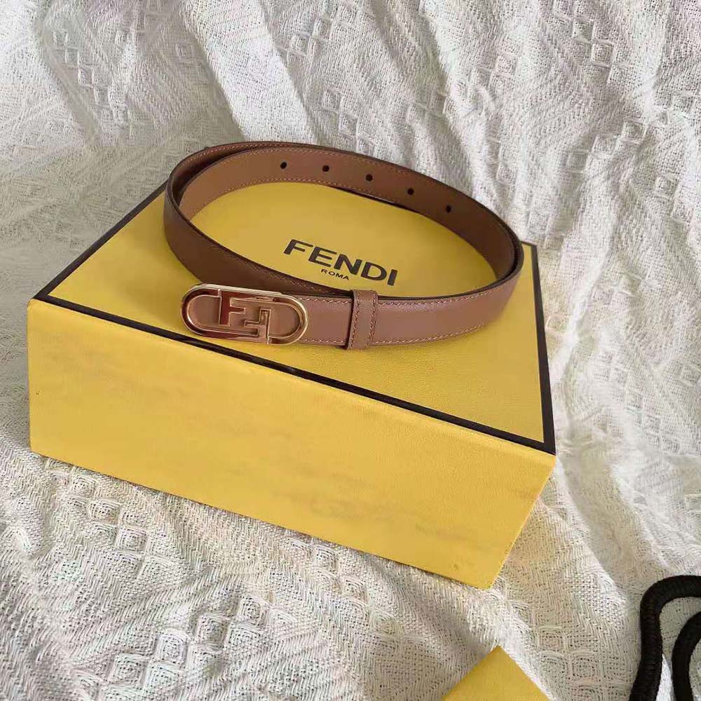 Close-up detail of Fendi OLock stud buckle on narrow beige belt