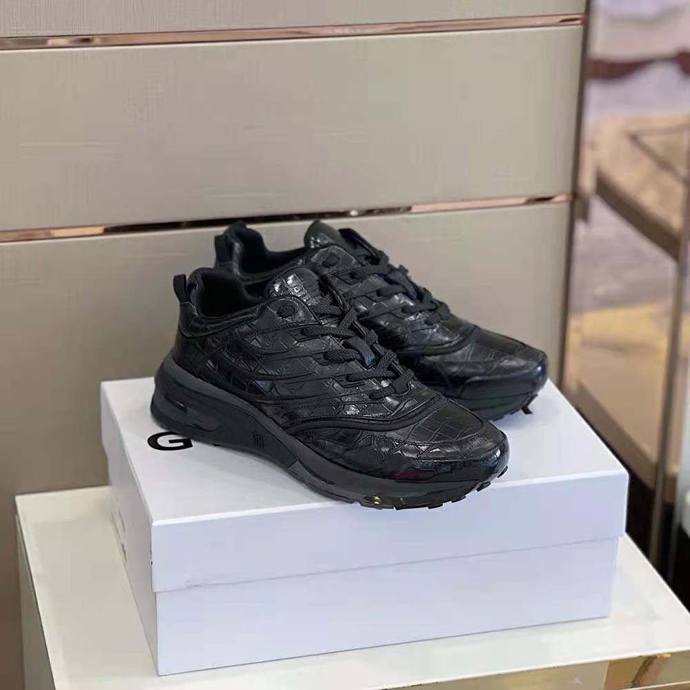 Overhead view showing lace closure and embossed Givenchy logo on sneakers
