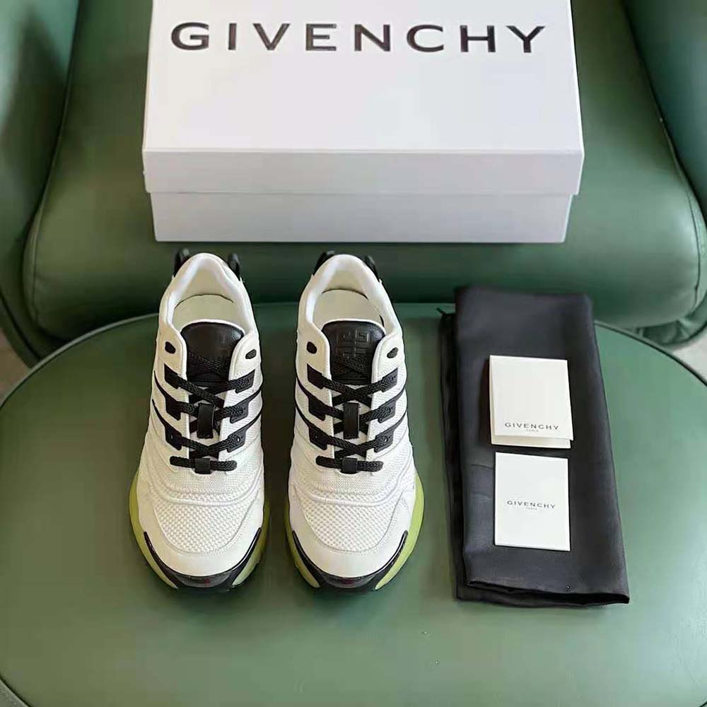 Close-up of Givenchy logo hardware on white Giv 1 Sneakers