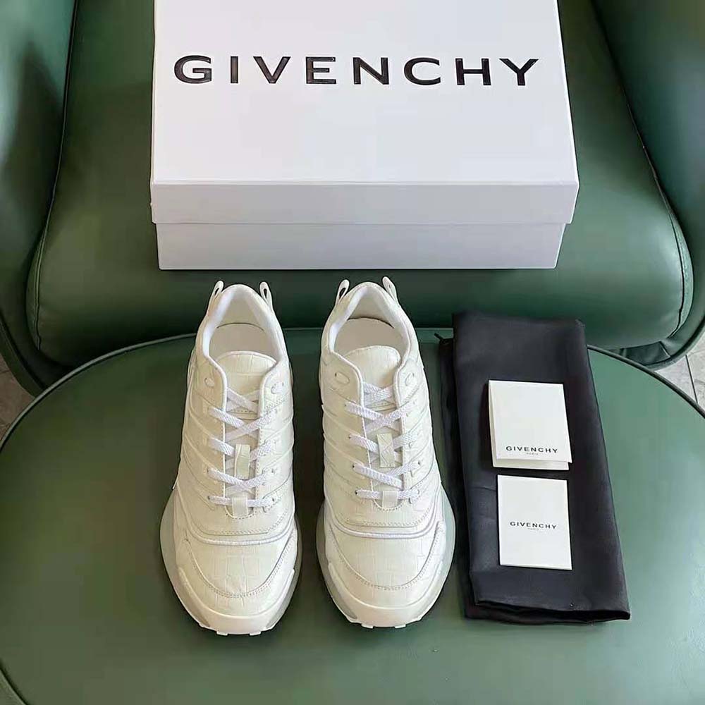 Close-up on embossed crocodile texture and Givenchy logo detail