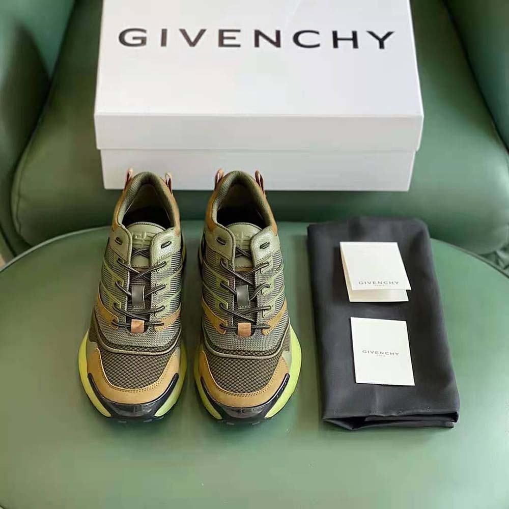 Close-up detail of Givenchy logo hardware on green sneakers