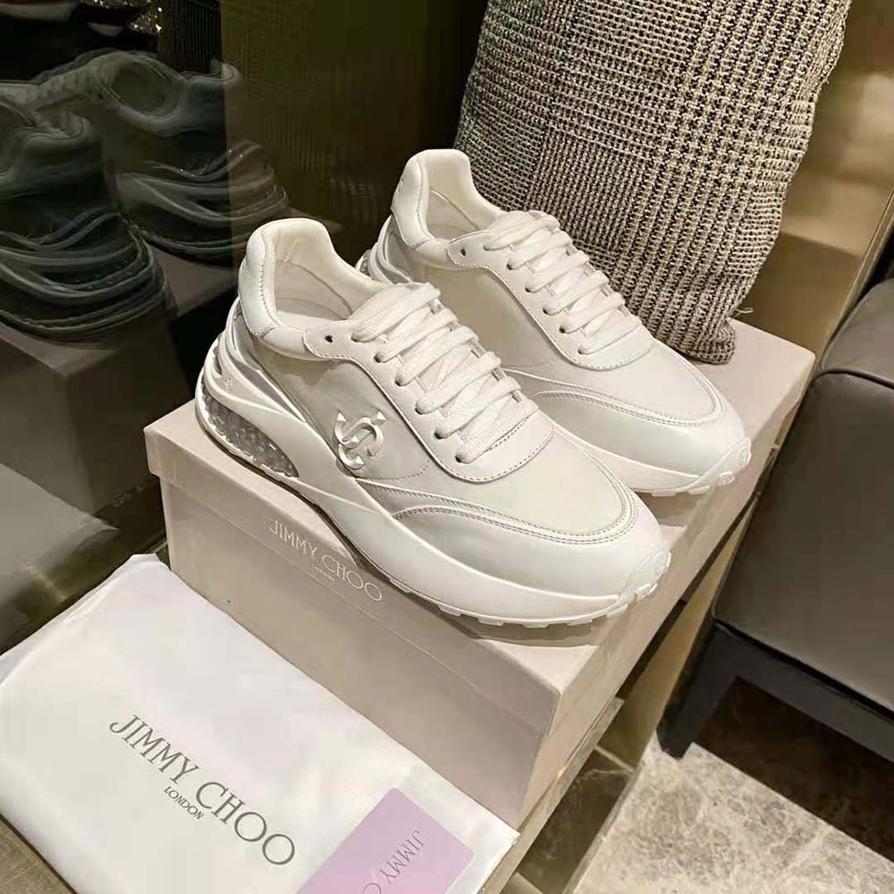 Close-up detail of white leather and neoprene on Jimmy Choo trainers