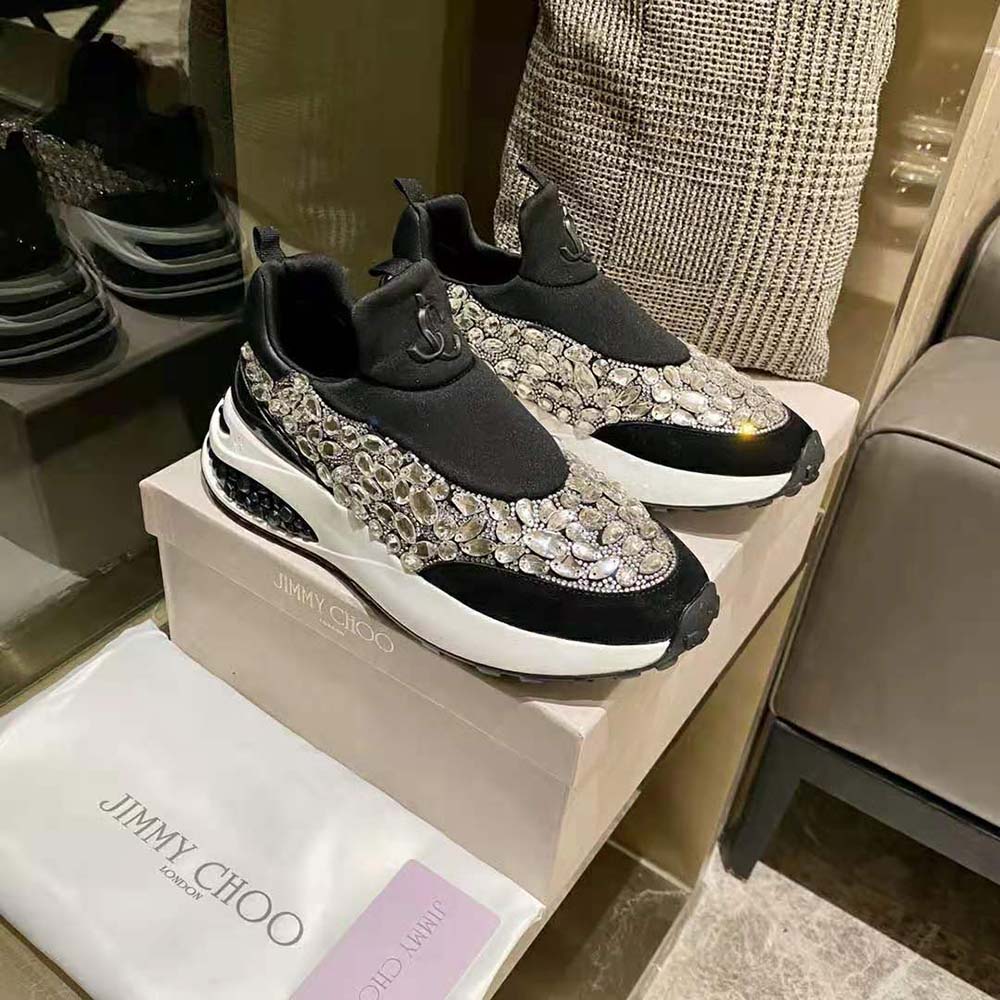Close-up of black neoprene and leather detail on Jimmy Choo trainers