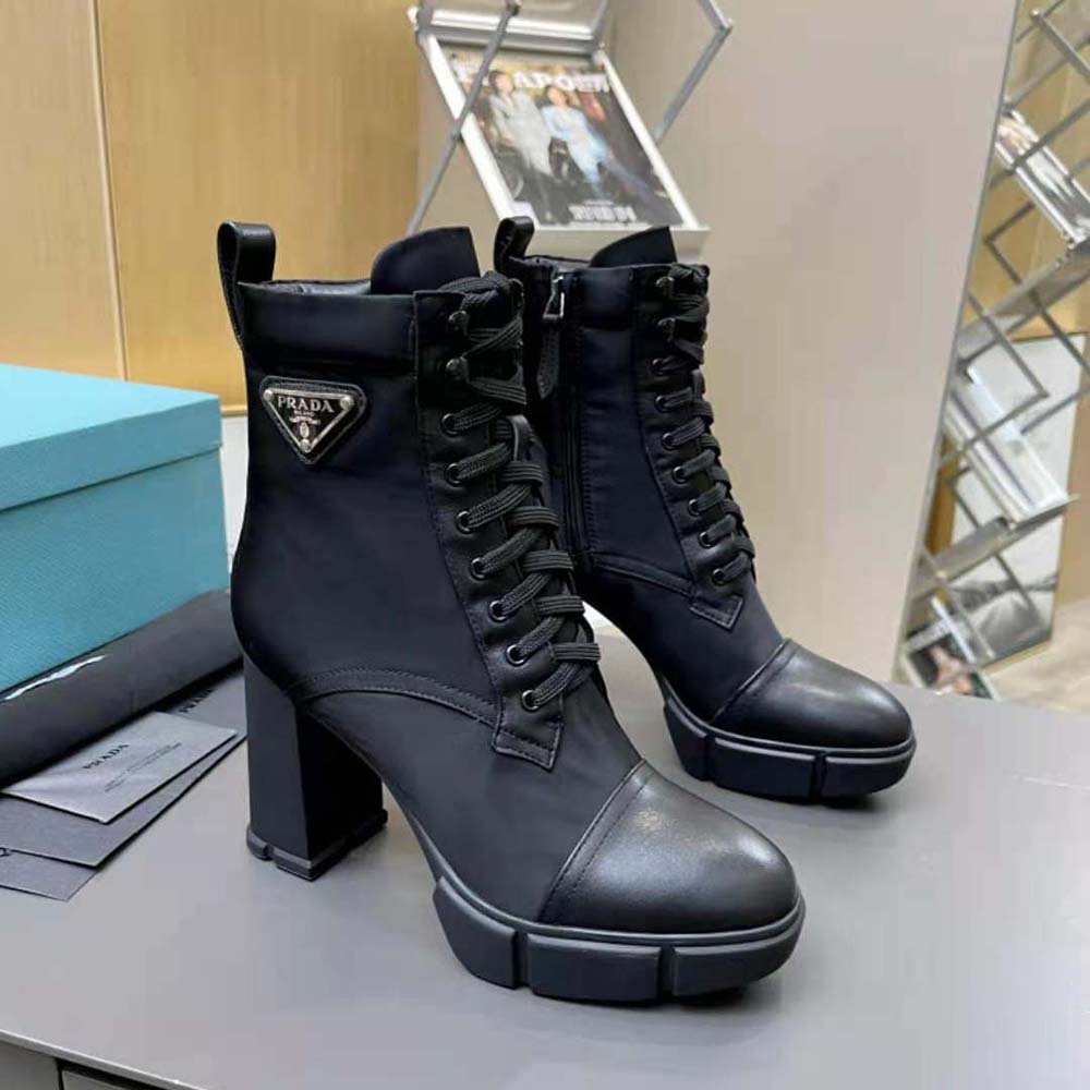 Close-up on gunmetal hardware and lace-up detail on Prada booties