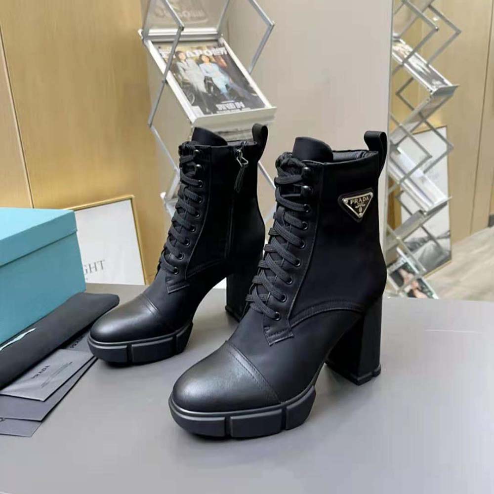 Top view showing brushed leather and nylon texture contrast on Prada booties
