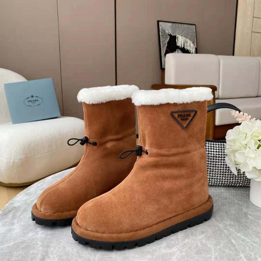 Top-down detail of plush interior lining in Prada shearling booties