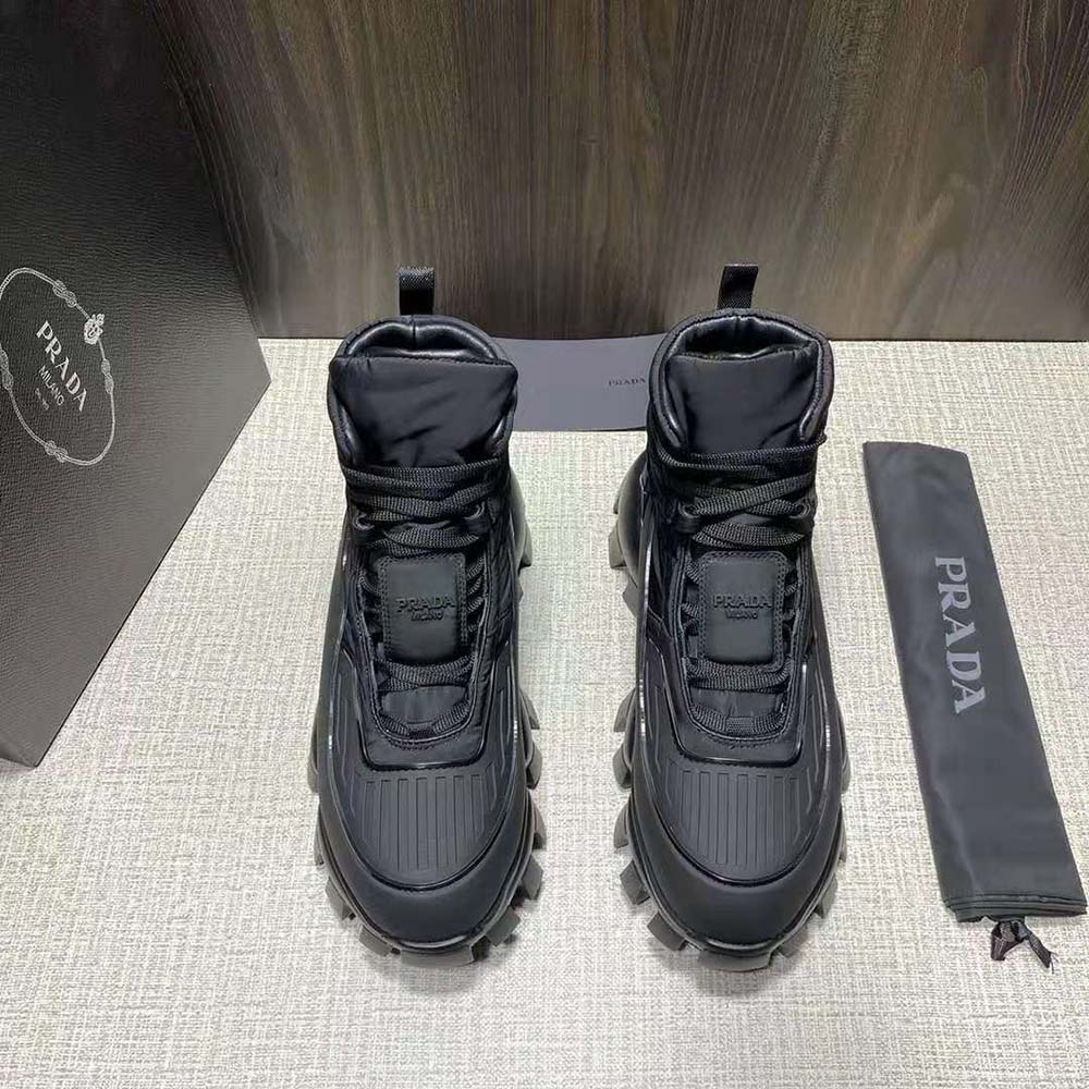 Close-up of Prada logo hardware on Prada Women Cloudbust Thunder Sneakers-Black tongue
