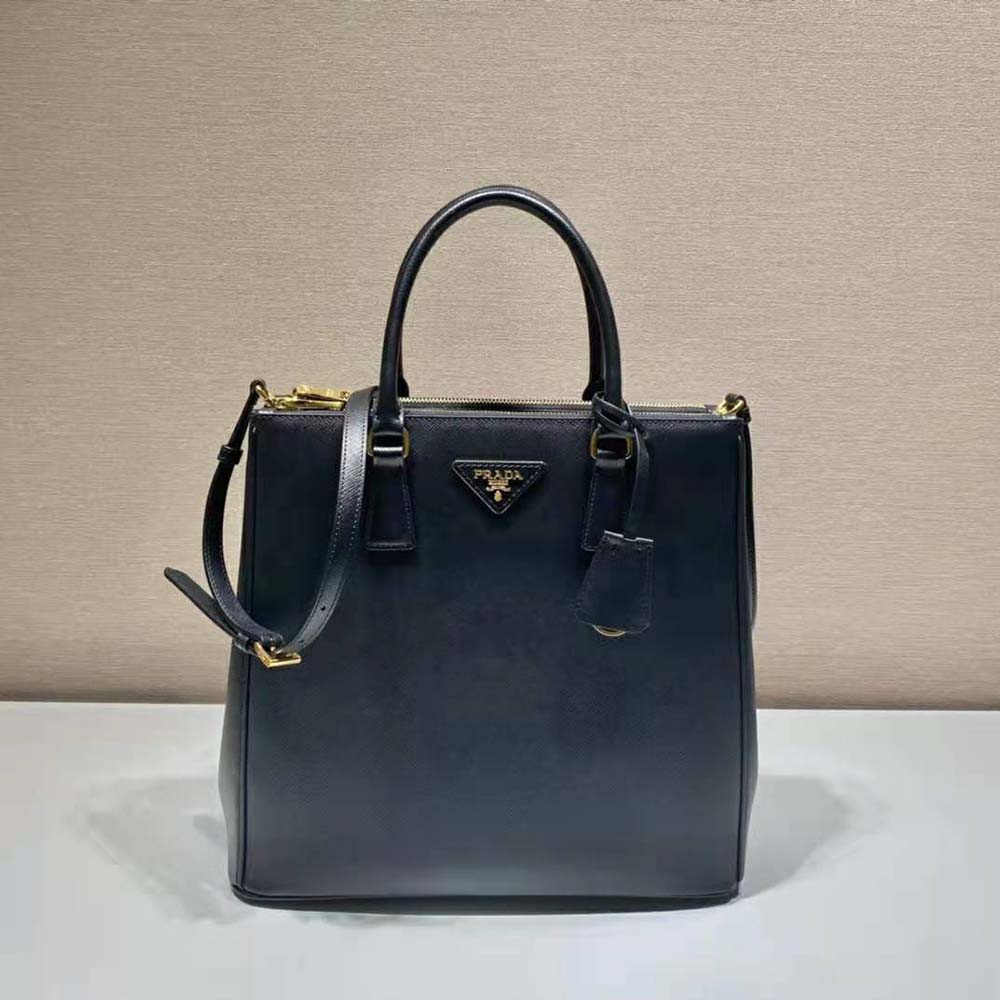 Close-up of black saffiano leather texture and gold hardware detail
