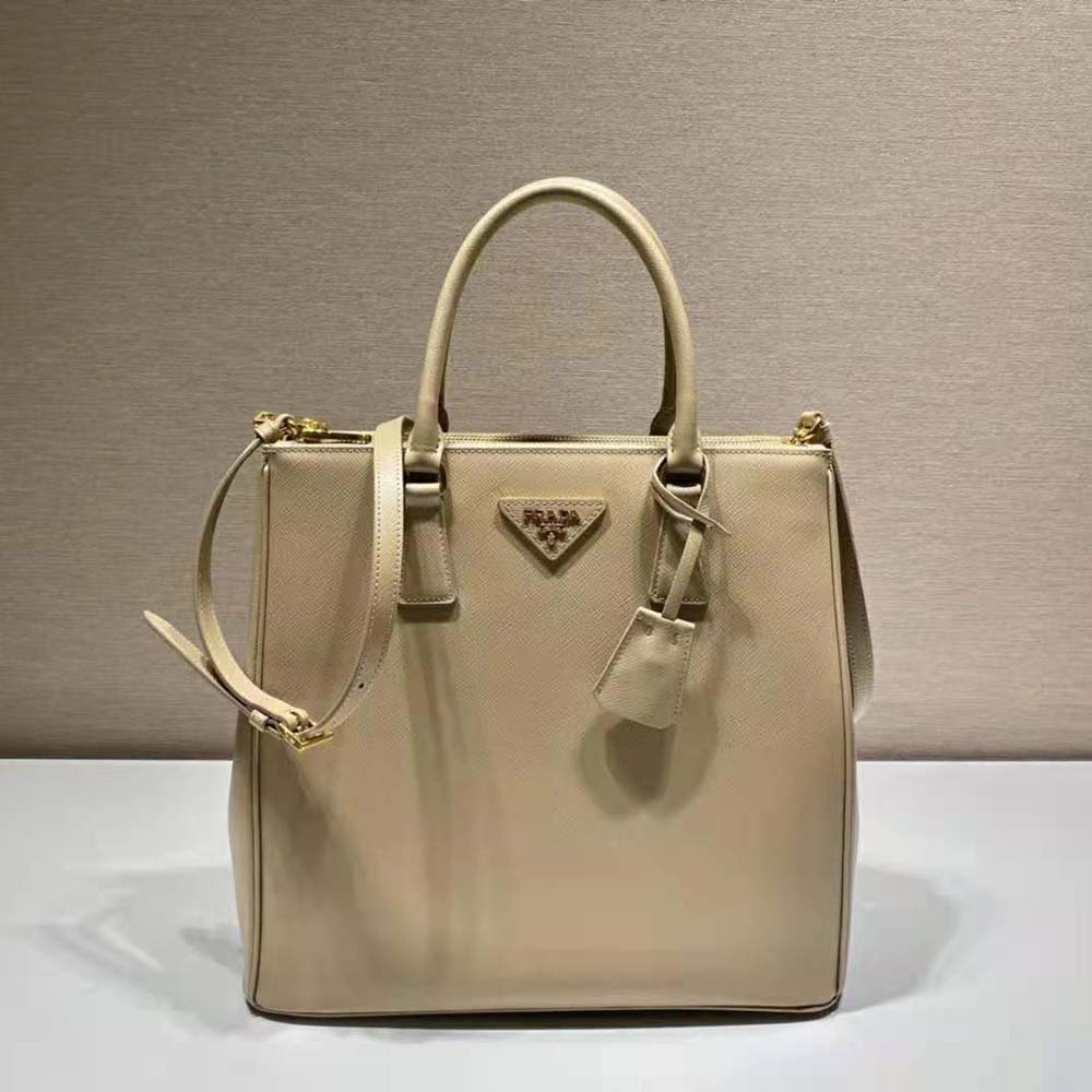 Close-up of sandy Saffiano leather texture and gold hardware