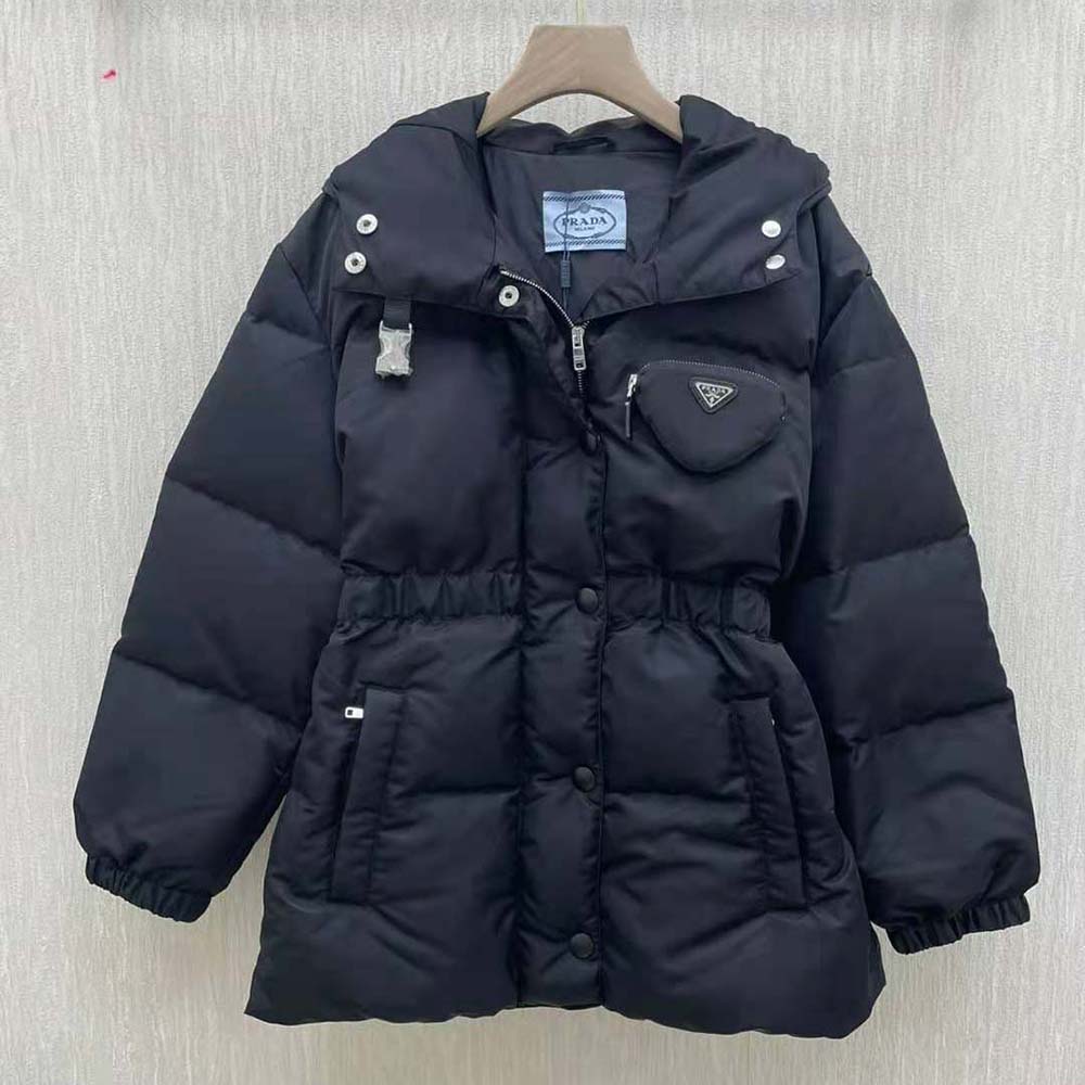 Close-up of Prada triangle logo hardware on black down jacket
