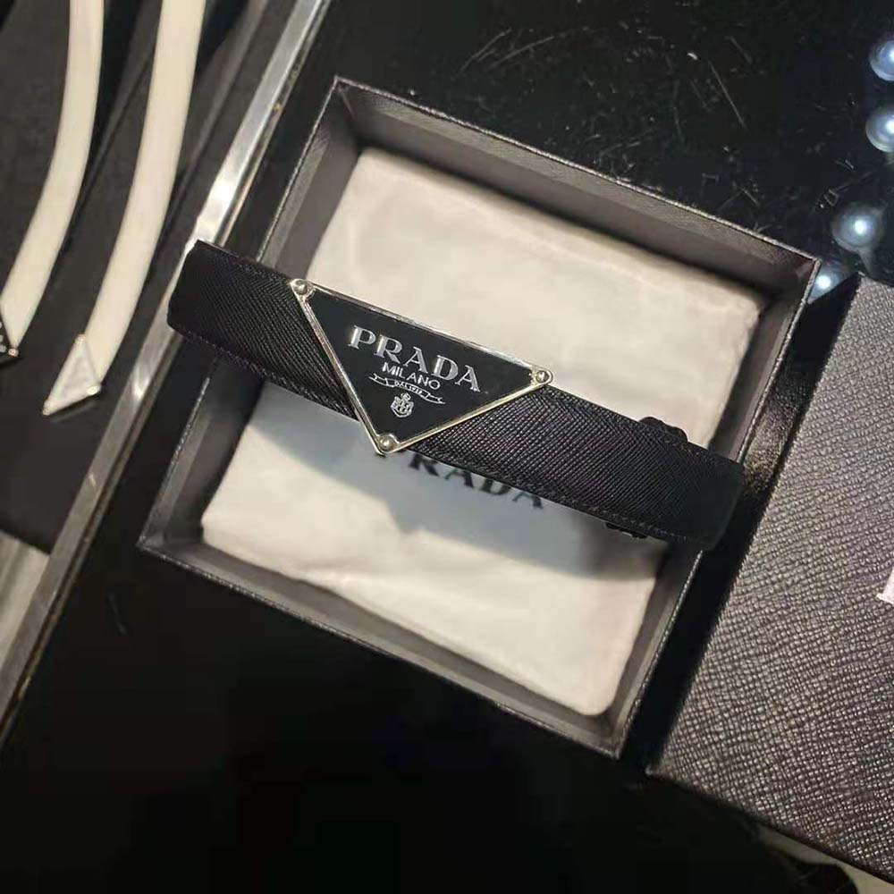Close-up detail of Prada logo on black saffiano leather belt
