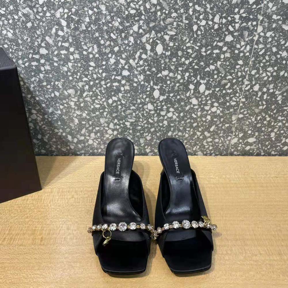 Close-up of gold Medusa hardware on Versace Women Artifact Mid-Heel Mules-Black