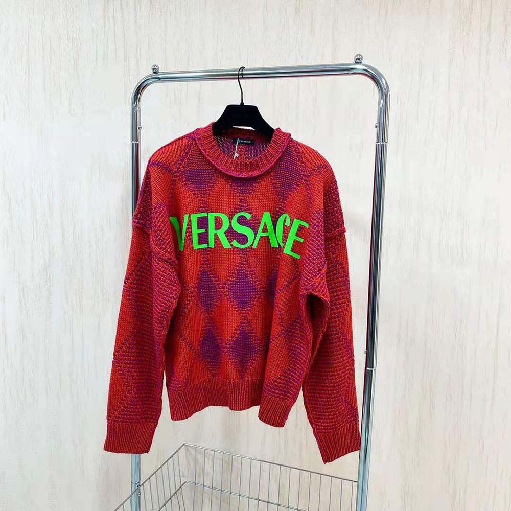 Close-up of Versace logo and Argyle pattern on red wool-alpaca sweater
