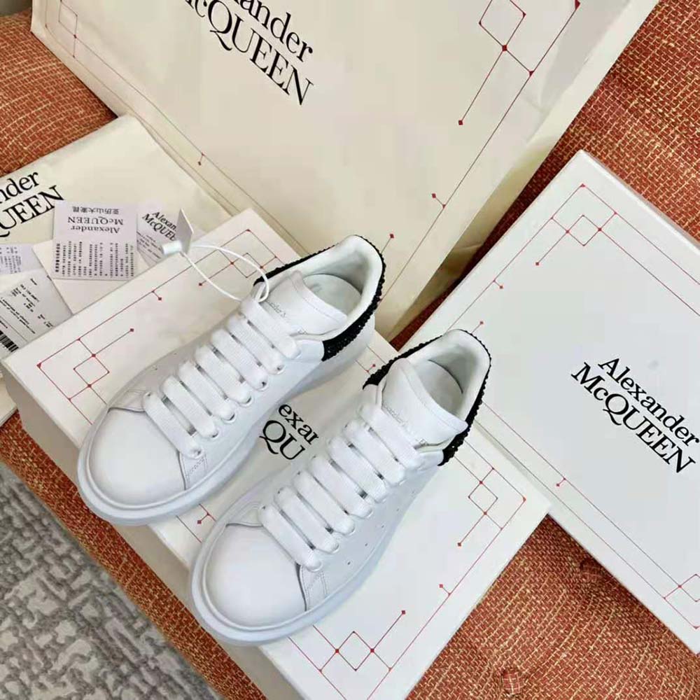 Close-up of white smooth calf leather and heel tab detail sneaker
