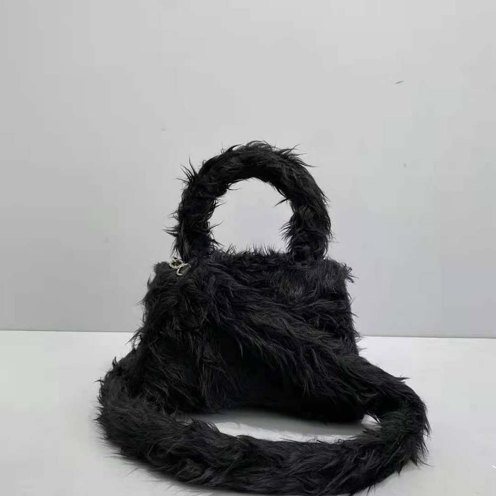 Close-up detail of fluffy fabric and silver-tone clasp on Balenciaga handbag