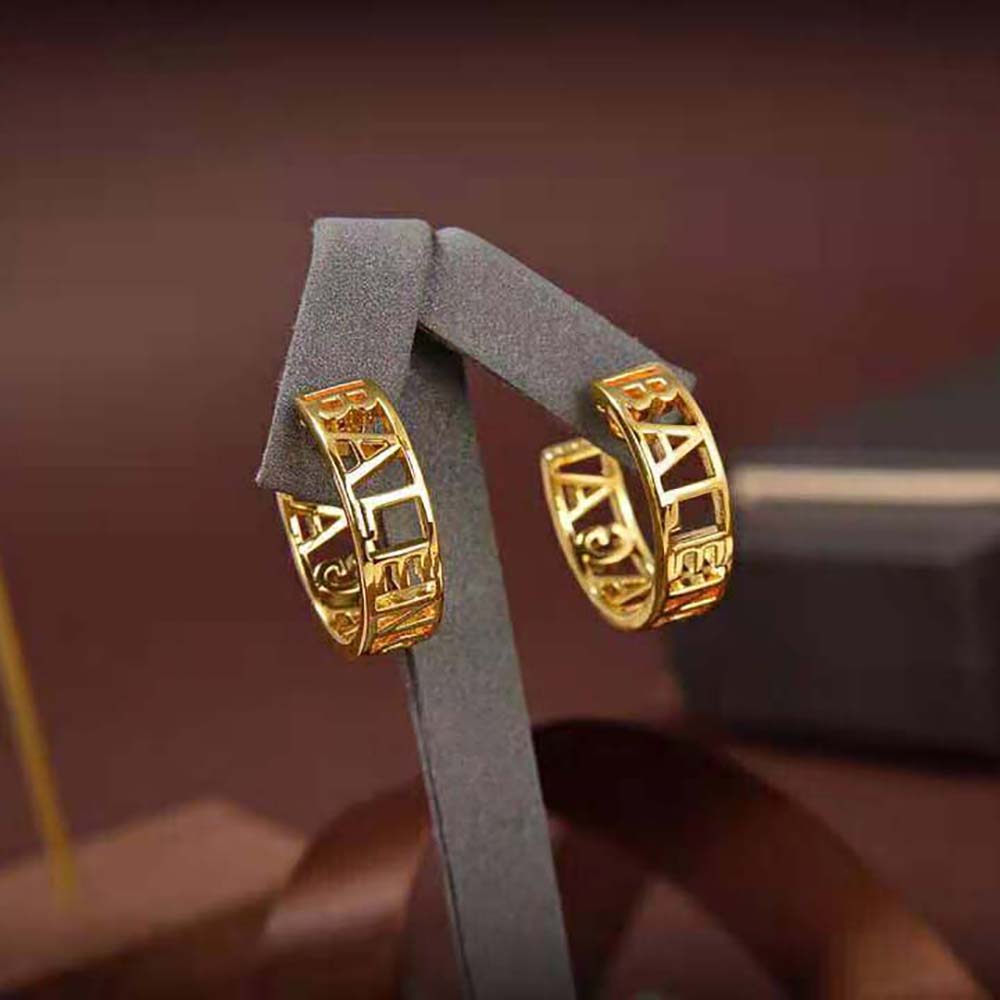 Side profile of sleek Balenciaga Women Logo Earrings in shiny gold