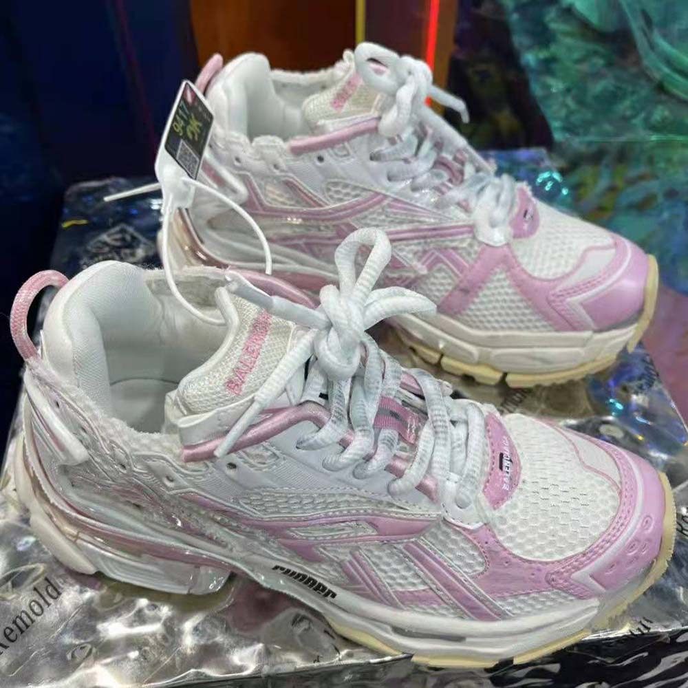 Close-up of pink mesh and signature Balenciaga logo on sneaker heel