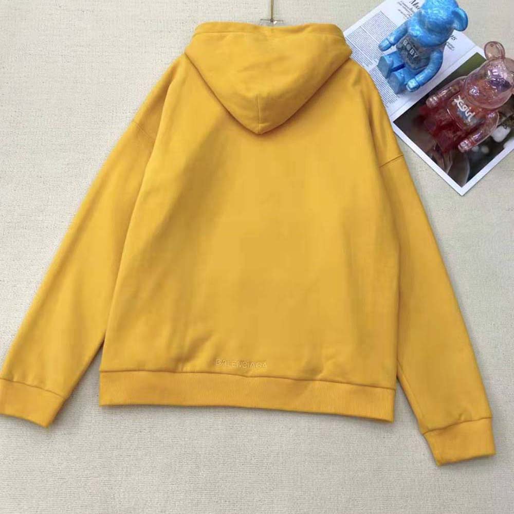 Side angle showing wide fit silhouette and hood details on Balenciaga hoodie