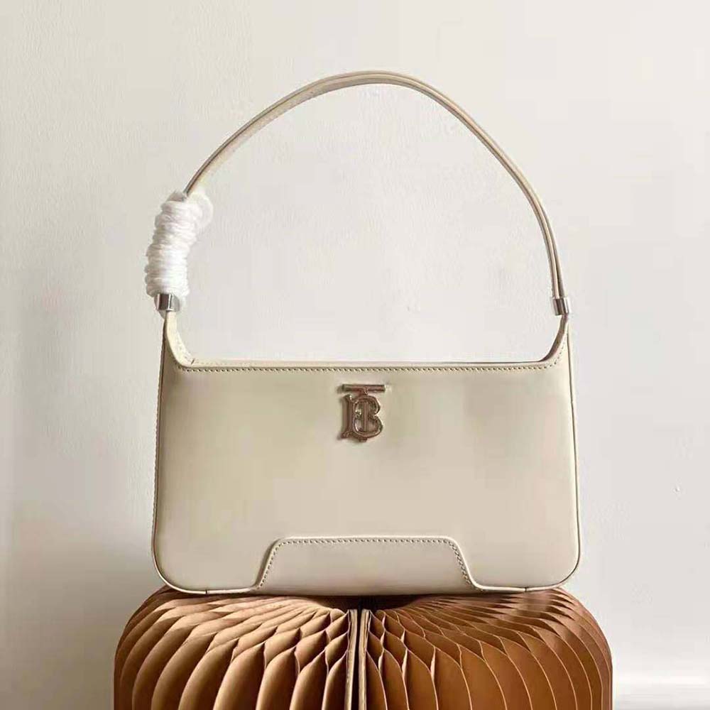 Close-up of smooth white leather and TB clasp detail on shoulder bag