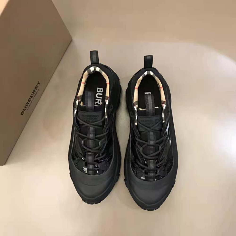 Close-up on patent leather and branded hardware on Arthur Sneakers